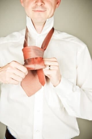 Elegant man with tie in professional photo studio in Munich, high-quality portrait shots, business photography, model shooting, personal photo shoot in Munich, photo studio in the city center.