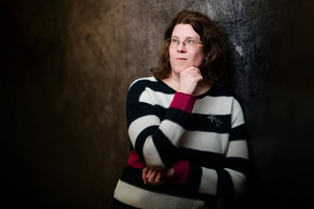 Thoughtful woman against a dark background for creative portrait photography